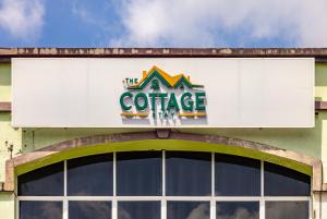 a large sign on top of a building at The Cottage Stay - self check-in in Kuching
