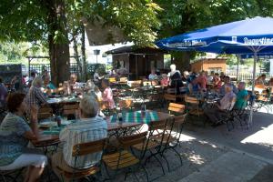 a group of people sitting at tables in a park at Gasthof Engel in Kaufbeuren