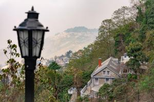 a street light in front of a house on a hill at Trippers CastleWoods in Darjeeling