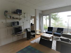a living room filled with furniture and a large window at Ferienhaus in am Teutoburger Wald in Husen