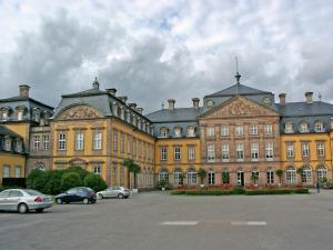 a large building with cars parked in a parking lot at Ferienhaus in am Teutoburger Wald in Husen