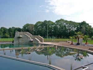 a pool of water with a staircase in a park at Ferienhaus in am Teutoburger Wald in Husen