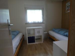 a small room with two beds and a window at Ferienhaus in am Teutoburger Wald in Husen +28 photos
