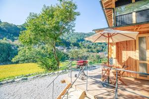 a patio with a table and an umbrella at Tiny House - Vacation STAY 12059v in Ōtakuchi