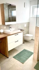 a bathroom with a sink and a toilet and a mirror at Alpen Liebe Prem in Prem