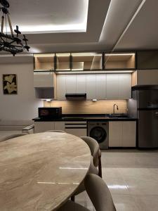 a kitchen with a table and a sink and a stove at Sharm Hills Azure Suite Topview in Sharm El Sheikh