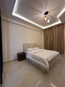 a bedroom with a bed and a ceiling at Sharm Hills Azure Suite Topview in Sharm El Sheikh