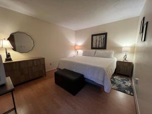 a bedroom with a bed and two lamps and a mirror at Private Mountain Condo in Wintergreen +41 photos