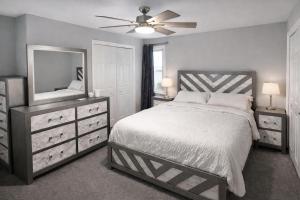 a bedroom with a bed and a dresser and a mirror at Spacious 3 bedroom duplex home inside Worcester in Worcester