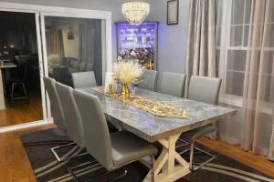 a dining room with a table with gray chairs at Spacious 3 bedroom duplex home inside Worcester in Worcester +4 photos