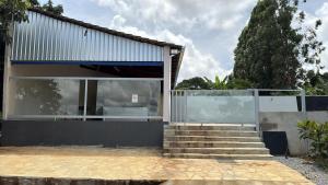 a house with a glass door and some stairs at Recanto do boto in Anápolis