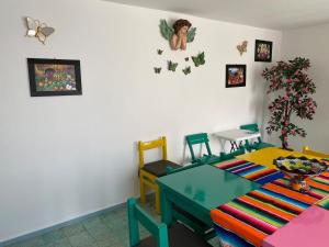 a room with a table and chairs and butterflies on the wall at Casa Girasoles in Orizaba