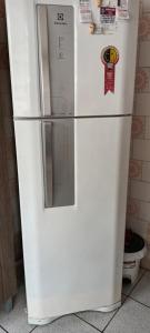 a white refrigerator in a kitchen with magnets on it at Pousada Maria Guapa 2 in São Gabriel