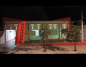 a building with a sign in front of it at Pousada Maria Guapa 2 in São Gabriel