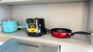 a toaster sitting on a counter next to a pot at Tanglin Tower with Netfix by AquHome in Surabaya