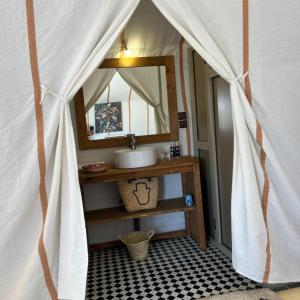 a bathroom with a sink and a mirror at Fantastic Luxury Dunes Camp in Merzouga +56 photos