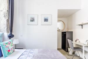 a white bedroom with a bed and a desk at AYZ Juan de Mena - Auto check-in property in Madrid