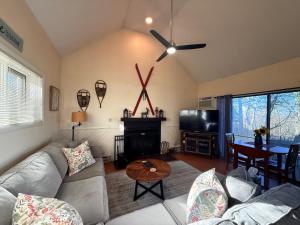 a living room with a couch and a table at Private Mountain Condo in Wintergreen