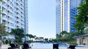a pool in the middle of two tall buildings at Tanglin Tower with Netfix by AquHome in Surabaya
