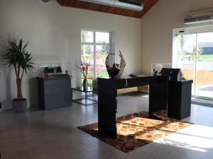 a room with a desk in a room with a table at Bemelen Holiday Home for 6 in Bemelen +32 photos
