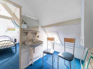 a bathroom with two chairs and a sink at Waterside stay with Private Jetty in Heeg