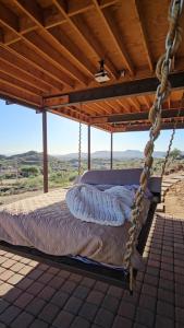 a swinging bed on a porch with a view at Desert Rain -Floating House in Anthem