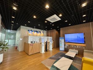 a room with a tv and a large screen at SR Hotel Yeongjong in Incheon +17 photos