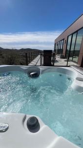 a jacuzzi tub with a view of a building at Desert Rain -Floating House in Anthem