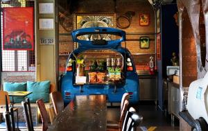 a bar in a restaurant with a blue van at MeStyle Garage Hotel in Bangkok