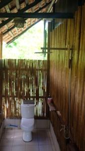 a bathroom with a toilet in a wooden wall at Binga Beach Resort in San Miguel +59 photos