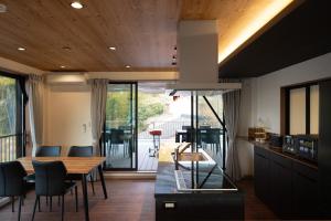 a kitchen and dining room with a table and chairs at URADO TERRACE Private villa 無料駐車場4台 最大10名 桂浜近く ジャグジー シアタールーム完備 in Kochi