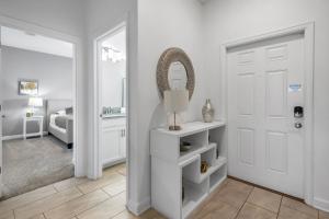 a white room with a door and a mirror at Resort Style, close to Disney and other parks in Davenport