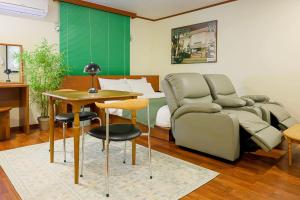 a living room with a couch and a table at Anook Hotel Jeonju in Jeonju