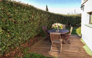 a table with chairs and a vase of flowers on it at Maison Avec Piscine in Salavas +10 photos