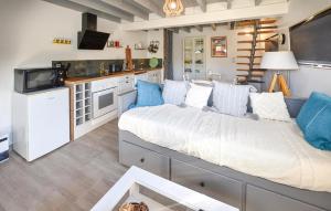 a bedroom with a large bed and a kitchen at Maison Avec Piscine in Salavas