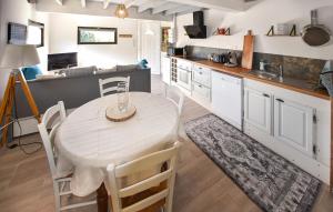 a kitchen with a table and chairs in a room at Maison Avec Piscine in Salavas