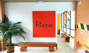 a red sign in a hallway with a bench at MeStyle Place Hotel in Bangkok +65 photos