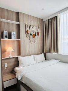 a bedroom with a large bed and a window at AC Nera Garden Apartment in Thôn Văn Dương +9 photos
