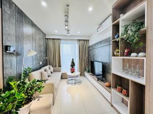 a living room with a couch and a tv at AC Nera Garden Apartment in Thôn Văn Dương