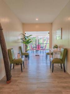 a dining room with chairs and a table and a table and chairsktop at Caliraya Music Camp in Cavinti