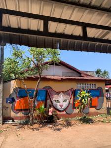 a painting of a cat on the side of a building at Pakse Chill Hostel in Pakse