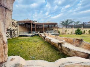 a building with a wooden fence in front of it at Dreams Garden VIP Villa in Sphinx International Airport