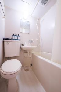 a white bathroom with a toilet and a sink at 茜 Akane in Kawasaki +24 photos