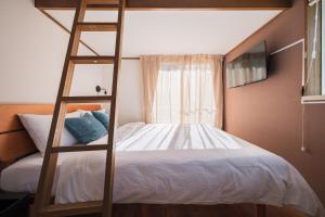 a bedroom with a bunk bed with a ladder at 茜 Akane in Kawasaki
