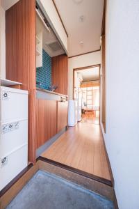 a hallway of a kitchen with a wooden floor at 茜 Akane in Kawasaki