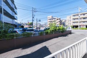 a street with cars parked in a parking lot at 茜 Akane in Kawasaki