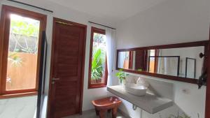 a bathroom with a sink and a mirror at Aramaya Hills Boutique in Banjar +63 photos