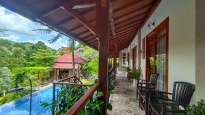 a balcony of a house with a swimming pool at Aramaya Hills Boutique in Banjar