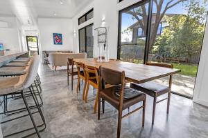a dining room with a wooden table and chairs at Sheoak in Paynesville