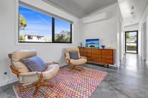 a living room with two chairs and a desk at Sheoak in Paynesville